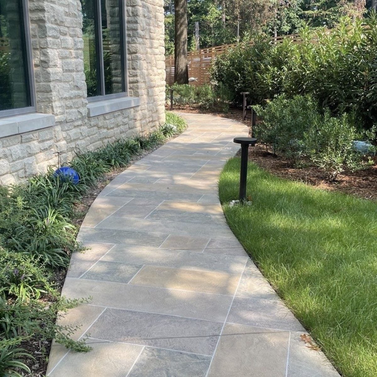 Bluestone walkway along stone facade